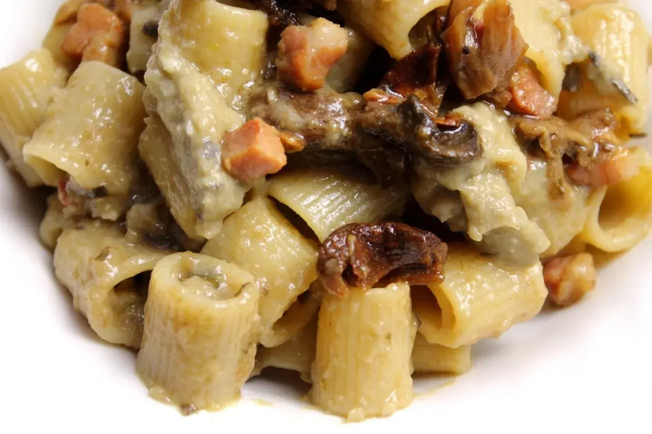 Primo piatto di pasta con melanzane e pancetta, un sapore intenso e avvolgente.