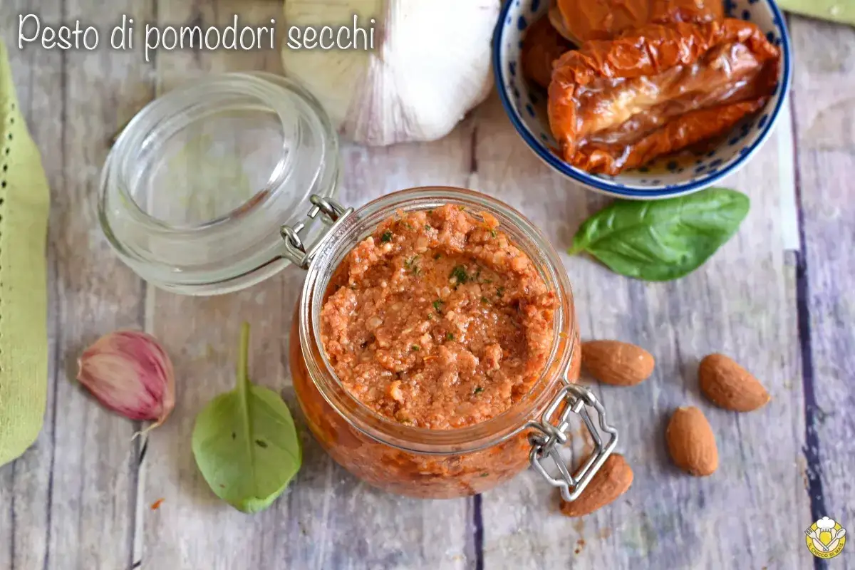 Un vasetto di pesto di pomodori secchi, con mandorle, aglio e basilico.